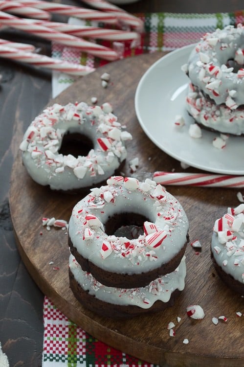 Baked chocolate donuts infused with peppermint flavor, topped with white chocolate and crushed candy canes. 
