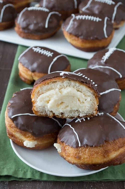 Cream Filled Chocolate Football Donuts - use refrigerated biscuits to make cream filled donuts! Decorate them to look like footballs for game day! 