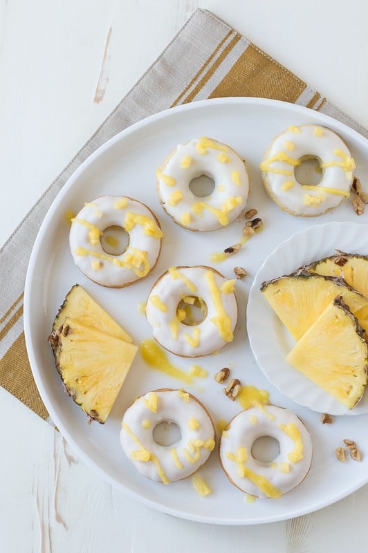 Pineapple Walnut Donuts with a white chocolate glaze and pineapple puree drizzle! 