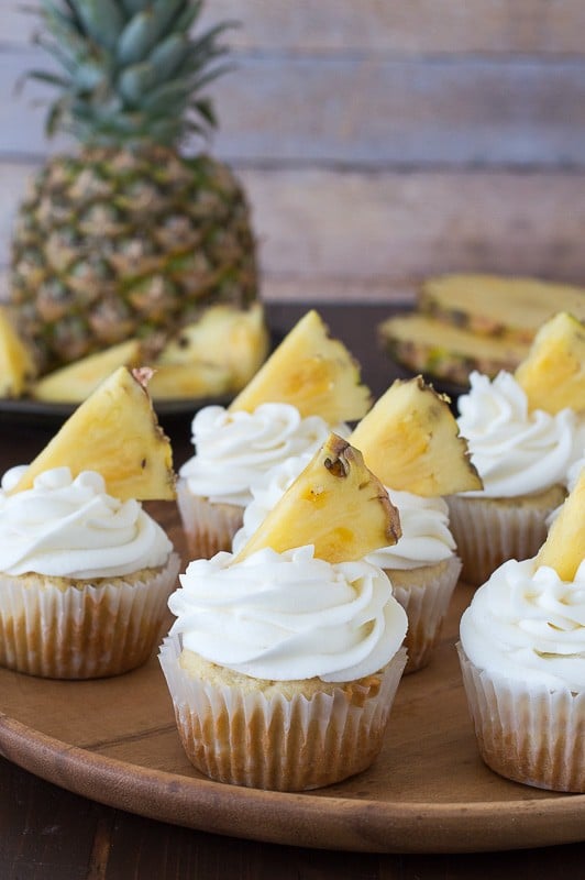 Pineapple Cupcakes - crushed pineapple in the batter and in the frosting! Top them with pineapple cookies or pineapple slices! 