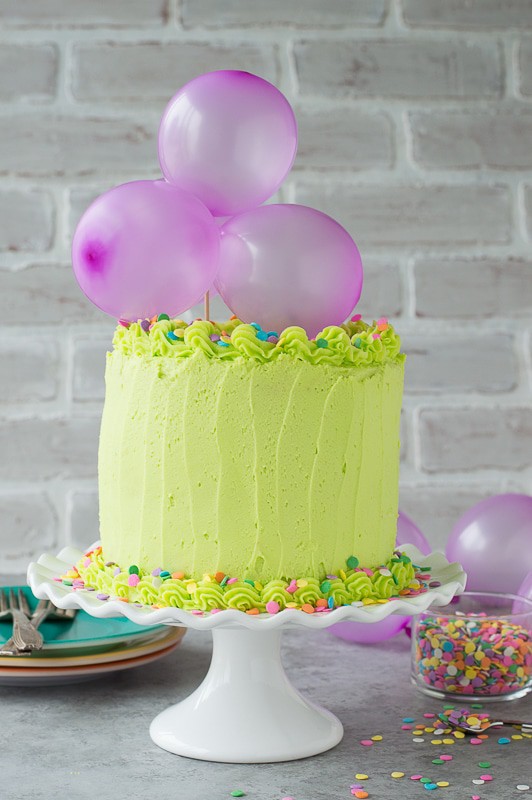 Homemade funfetti cake with lime green buttercream! Top the cake with a DIY balloon cake topper! 