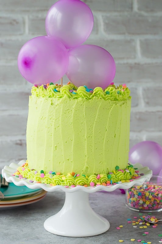 Homemade funfetti cake with lime green buttercream! Top the cake with a DIY balloon cake topper! 