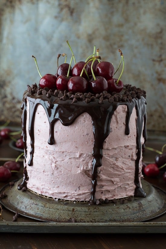A 3 layer white cake filled with chopped cherries and cherry buttercream. Topped with a drizzled chocolate ganache and fresh cherries! 