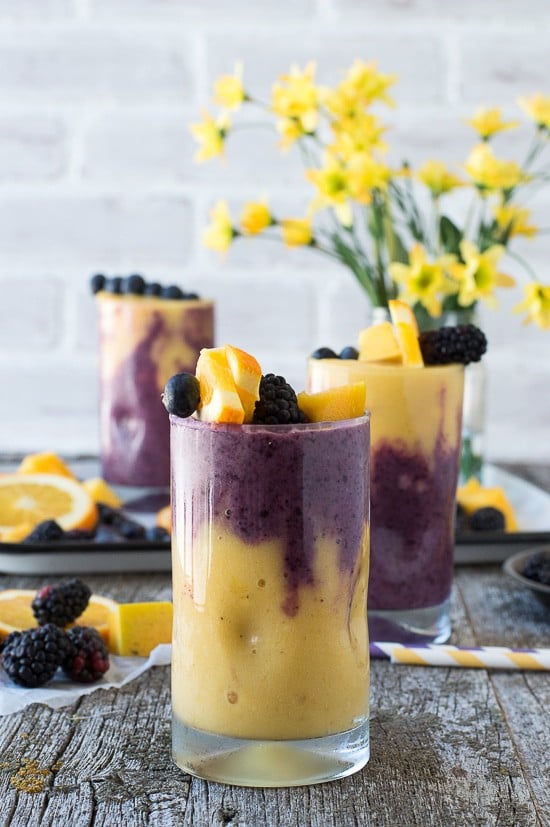 This two layer Hawaiian Berry Smoothie has an orange mango layer and a berry layer! Top the smoothie with a skewer filled with fresh fruit! 