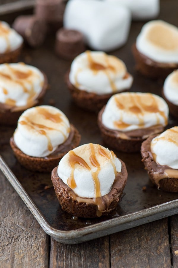 A twist on classic s’mores -Turtle S’mores Bites! Made with a pecan graham cracker crust, rolo’s, and toasted marshmallows! Make them in the oven in less than 20 minutes!