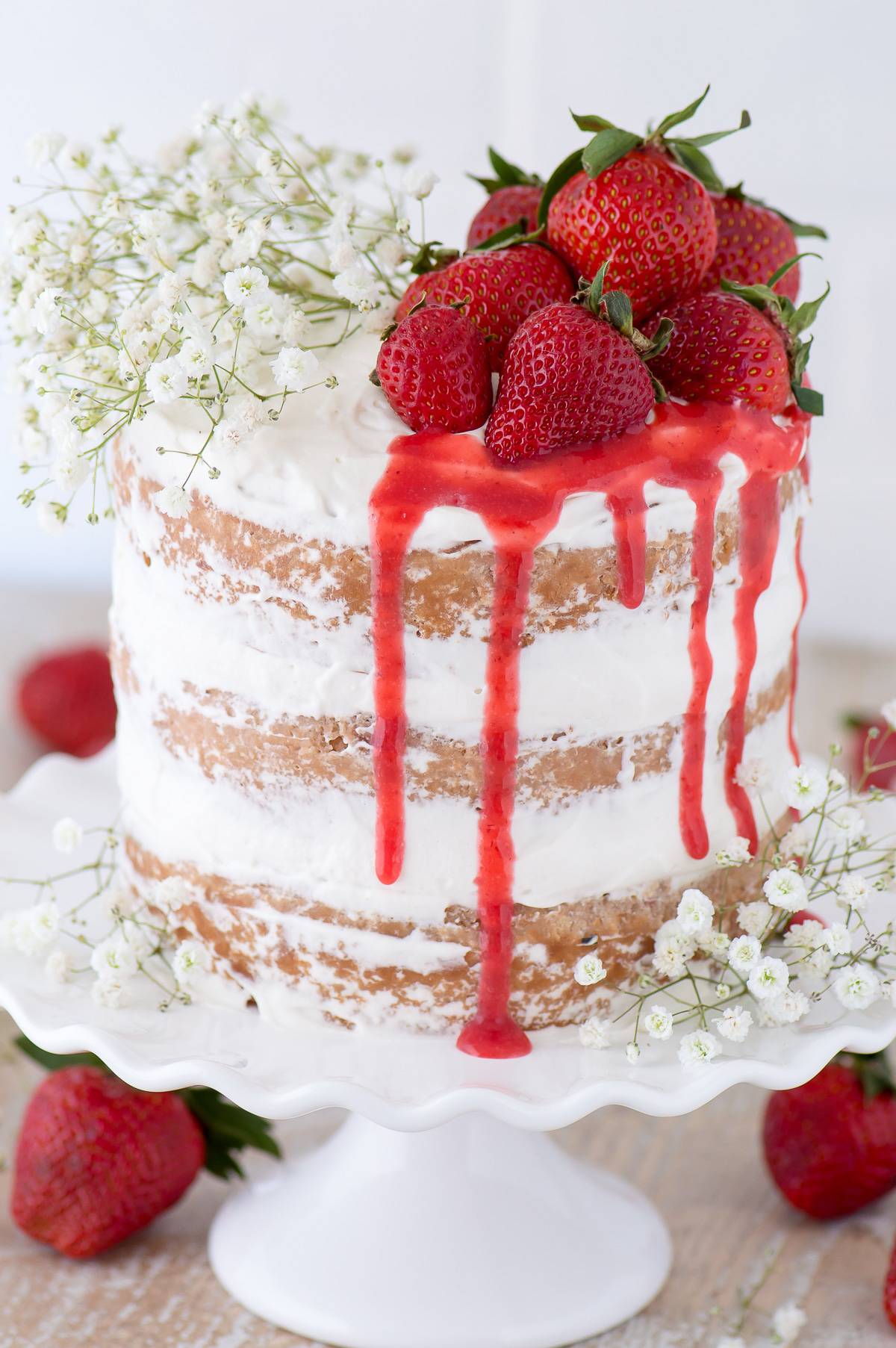 This strawberry naked cake is made with fresh pureed strawberries and is paired with homemade sweet cream whipped cream! Like a strawberries and cream cake!