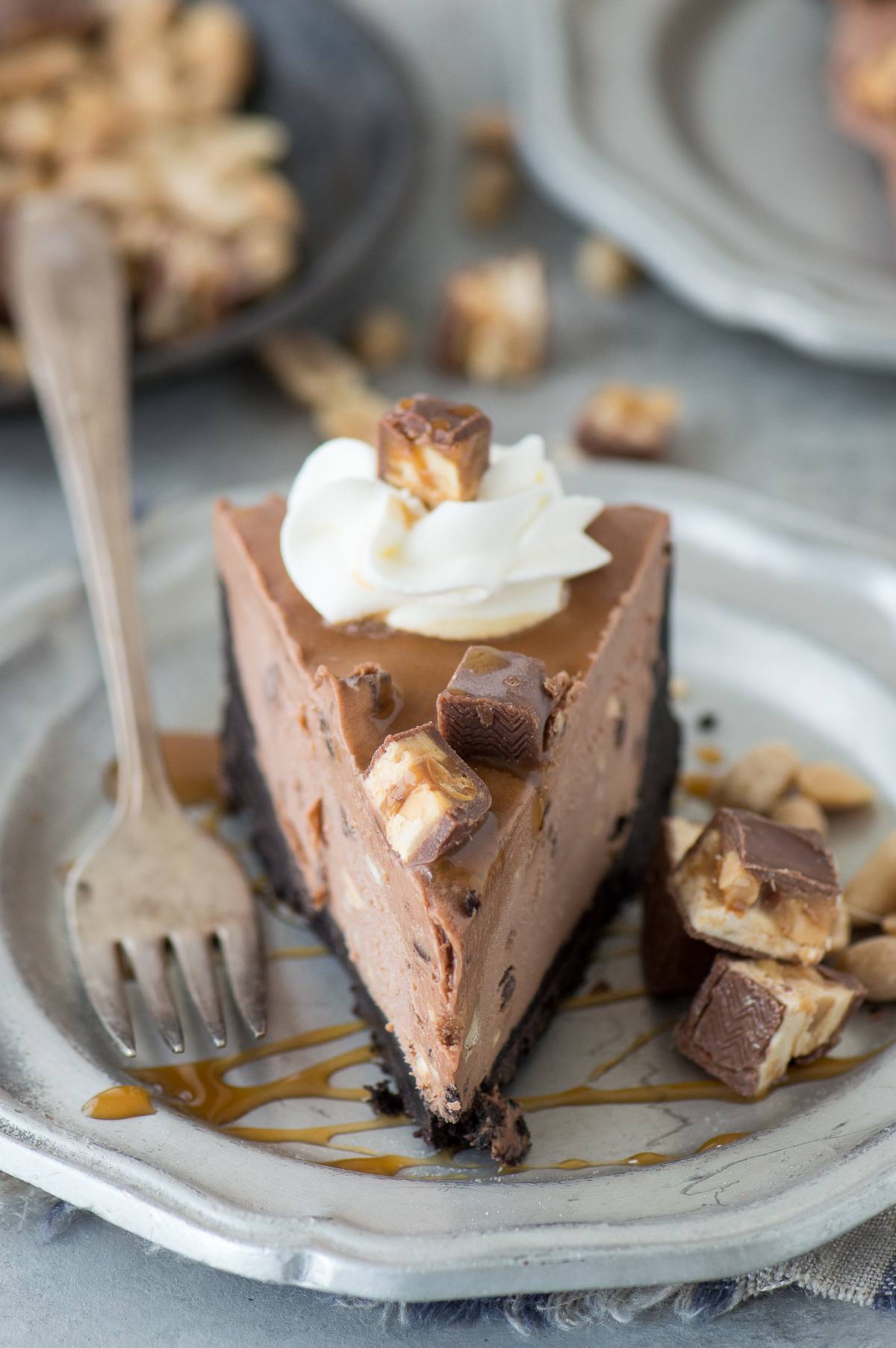 Hot Mess Nutella Snickers Pie - a no bake pie with an oreo crust, nutella cheesecake filling, topped with snickers pieces! #beyondfrostingcookbook