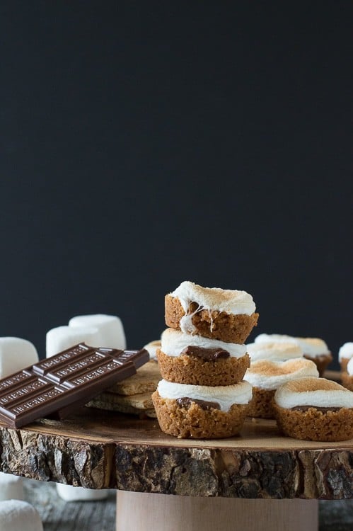 3 s'mores bites in a stack on round wood cake stand