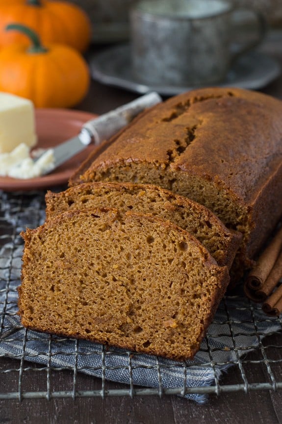 pumpkin bread loaf sliced into 2 pieces on metal cooling rack