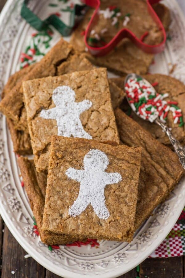 gingerbread brownies dusted with powdered sugar gingerbread men on a white platter