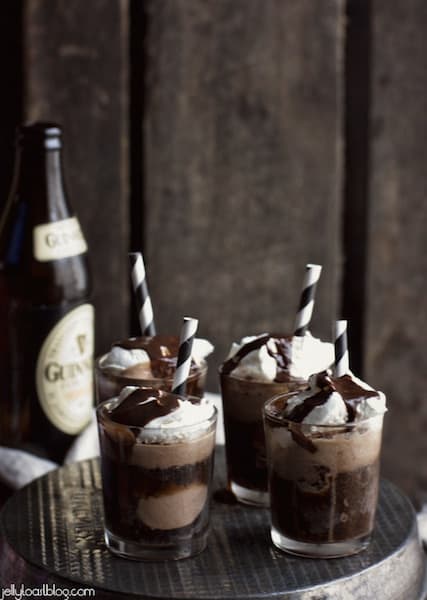 Four Mini Guinness Chocolate Floats in small glasses with brown and white striped straws.