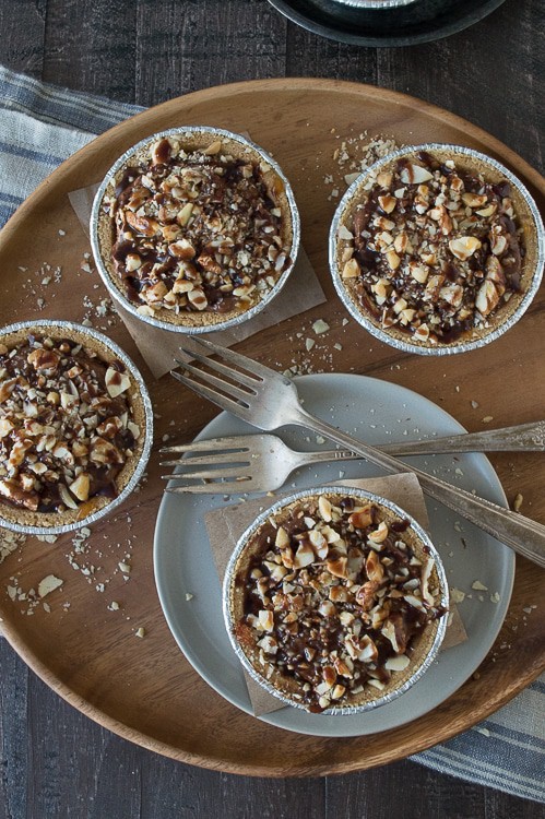 No bake mini pies with 2 layers of mixed nuts and a rich chocolate filling, all topped with chocolate and caramel! 