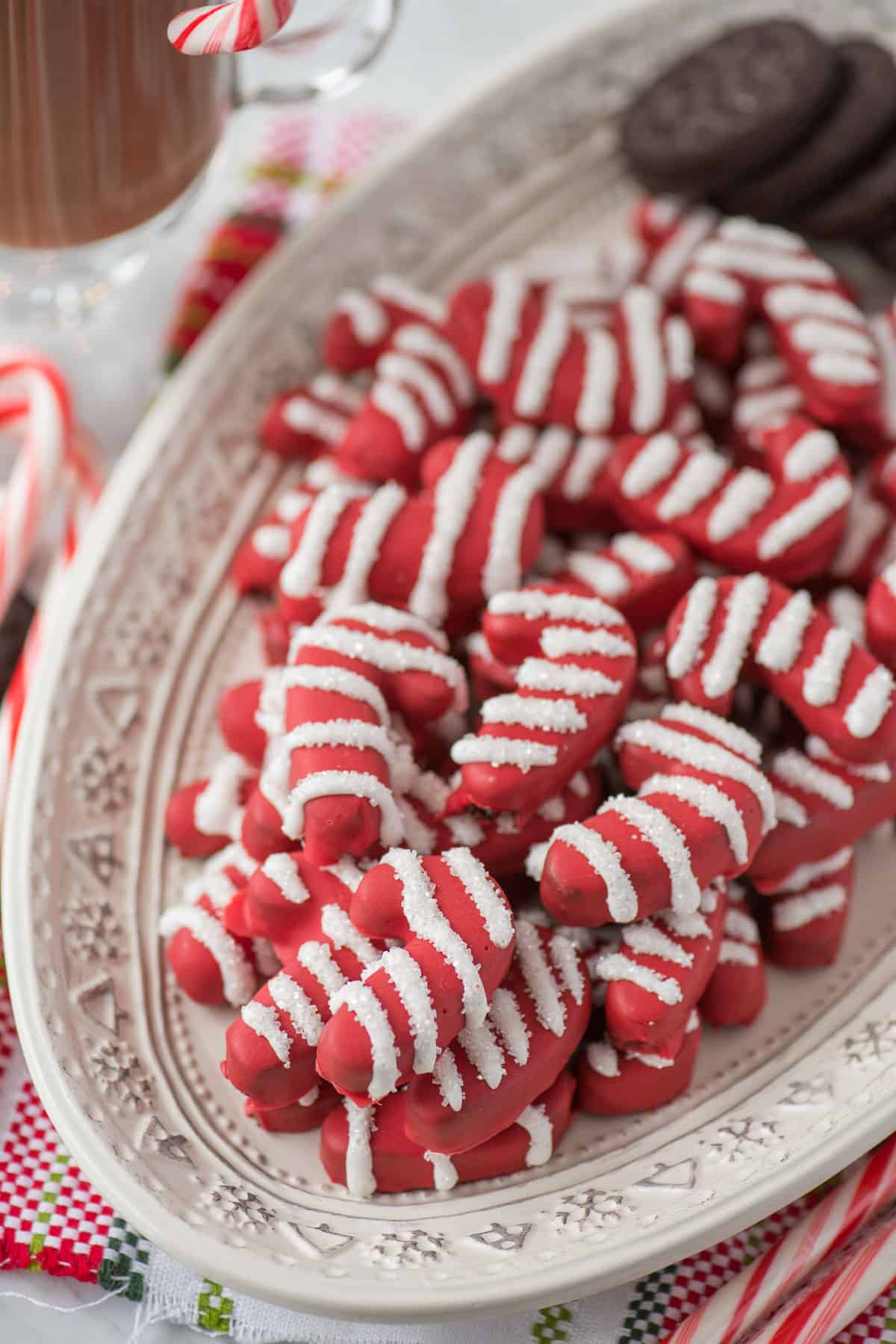 candy cane shaped oreo balls on white platter