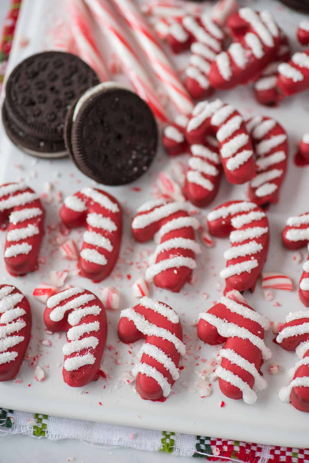 candy cane shaped oreo balls on white platter 