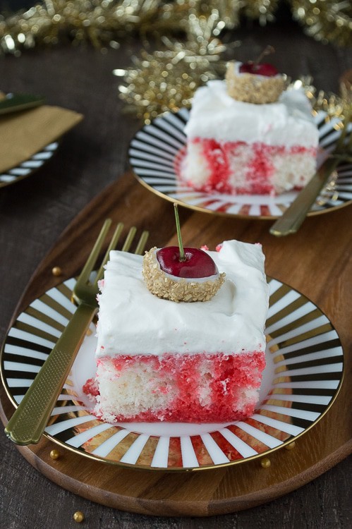 A poke cake infused with champagne and cherry, all topped with white chocolate cherries dipped in gold glitter! This would be perfect for New Year’s Eve!