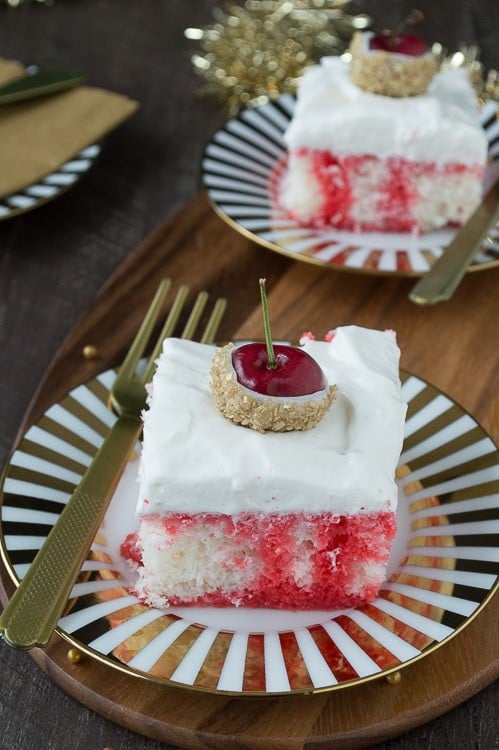 A poke cake infused with champagne and cherry, all topped with white chocolate cherries dipped in gold glitter! This would be perfect for New Year’s Eve!