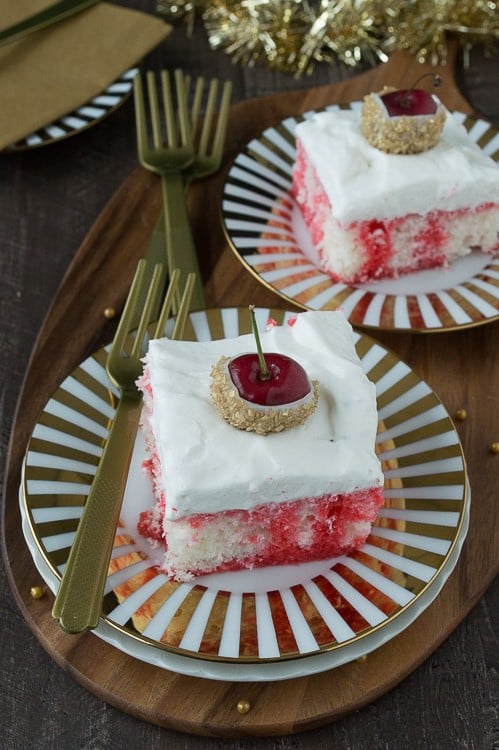 A poke cake infused with champagne and cherry, all topped with white chocolate cherries dipped in gold glitter! This would be perfect for New Year’s Eve!