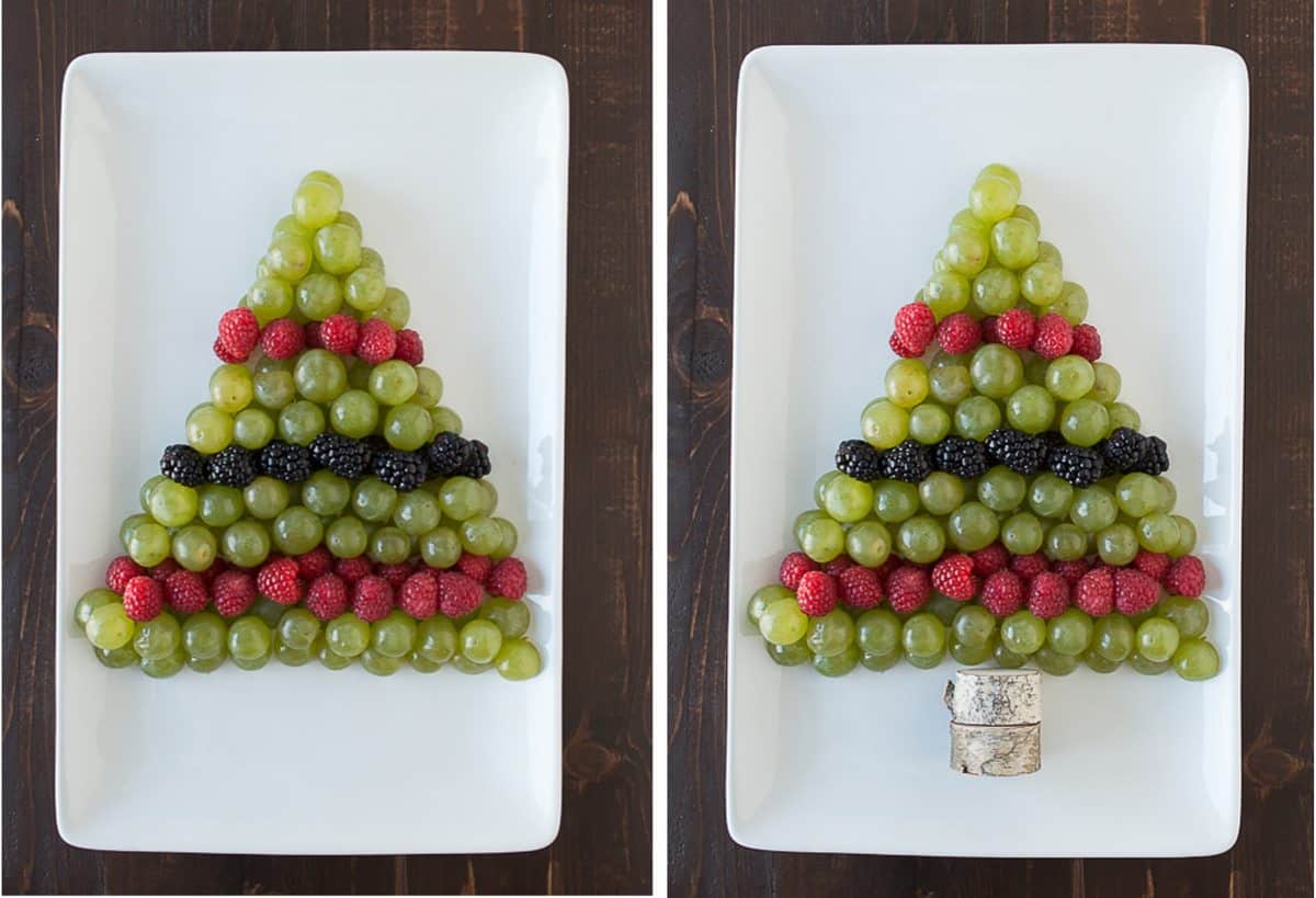 green grapes, raspberries and blackberries arranged to look like a Christmas tree on white platter