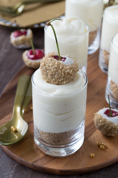 Make these fancy and easy white chocolate champagne cheesecake shooters for New Years Eve! I LOVE the cherries dipped in gold sprinkles! 