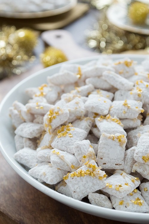 Easy white chocolate puppy chow with gold sprinkles and edible gold stars! This is perfect to make for New Year's Eve!