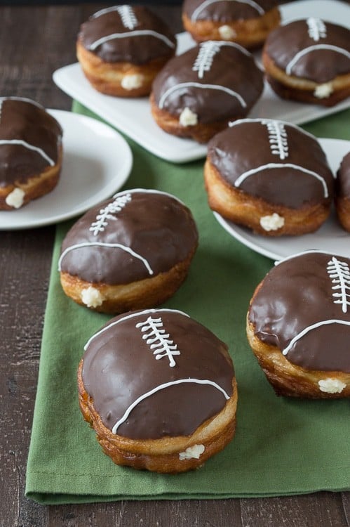 Cream Filled Chocolate Football Donuts - use refrigerated biscuits to make cream filled donuts! Decorate them to look like footballs for game day! 