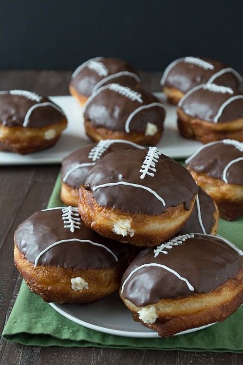 Cream Filled Chocolate Football Donuts - use refrigerated biscuits to make cream filled donuts! Decorate them to look like footballs for game day! 