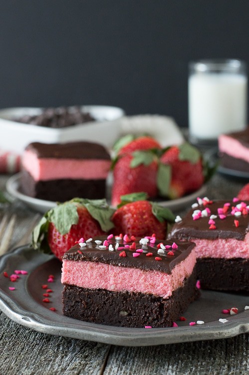 Layered Strawberry Mousse Brownies - a rich chocolate brownie topped with strawberry mousse and chocolate ganache. A favorite for Valentine’s Day!