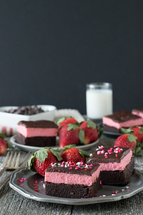 Layered Strawberry Mousse Brownies - a rich chocolate brownie topped with strawberry mousse and chocolate ganache. A favorite for Valentine’s Day!