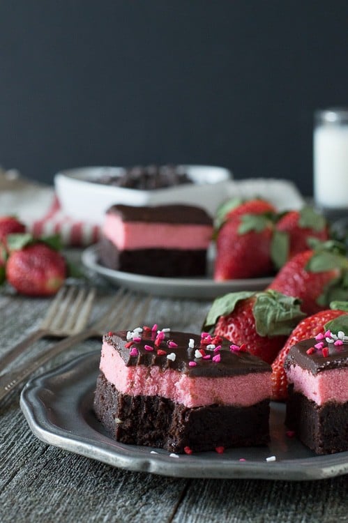 Layered Strawberry Mousse Brownies - a rich chocolate brownie topped with strawberry mousse and chocolate ganache. A favorite for Valentine’s Day!