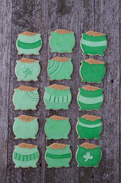 Fifteen homemade Pot o' Gold Cookies on a wooden table.