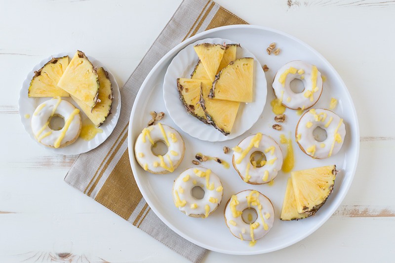 Pineapple Walnut Donuts with a white chocolate glaze and pineapple puree drizzle! 