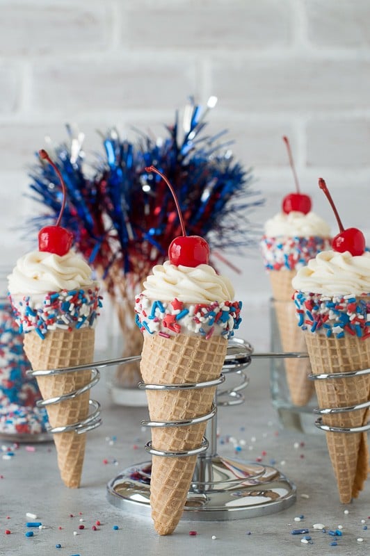 4th of July Cheesecake Ice Cream Cones - no bake vanilla cheesecake piped into 4th of july ice cream cones! 