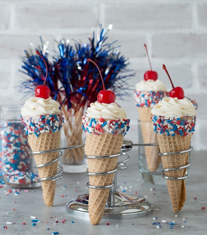 4th of July Cheesecake Ice Cream Cones - no bake vanilla cheesecake piped into 4th of july ice cream cones! 