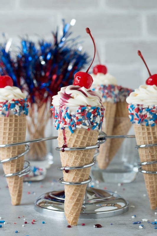 4th of July Cheesecake Ice Cream Cones - no bake vanilla cheesecake piped into 4th of july ice cream cones! 