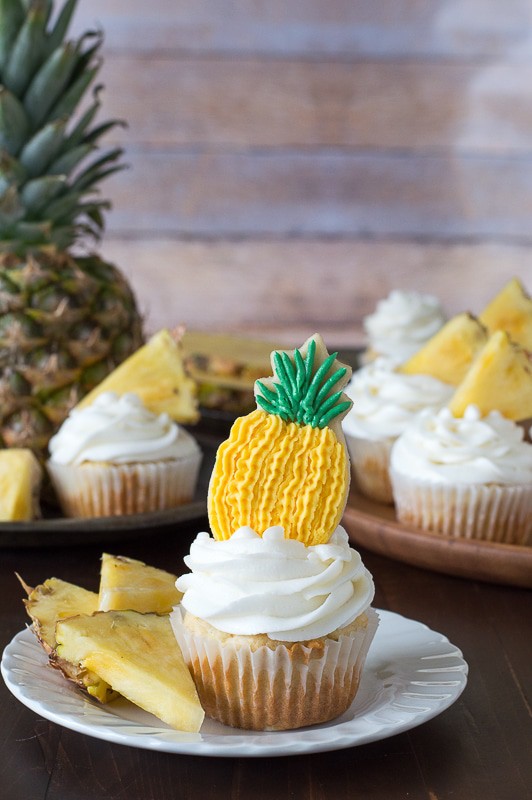 Pineapple Cupcakes - crushed pineapple in the batter and in the frosting! Top them with pineapple cookies or pineapple slices! 