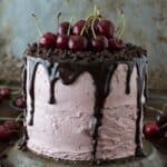 A 3 layer white cake filled with chopped cherries and cherry buttercream. Topped with a drizzled chocolate ganache and fresh cherries!