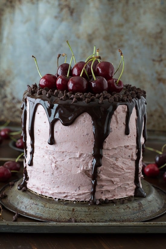 A 3 layer white cake filled with chopped cherries and cherry buttercream. Topped with a drizzled chocolate ganache and fresh cherries!