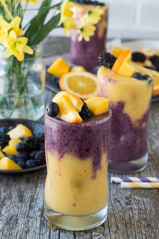 This two layer Hawaiian Berry Smoothie has an orange mango layer and a berry layer! Top the smoothie with a skewer filled with fresh fruit! 