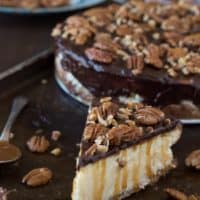 This is the best turtle cheesecake! It’s rich and so creamy. Topped with chocolate ganache, pecans and caramel sauce.