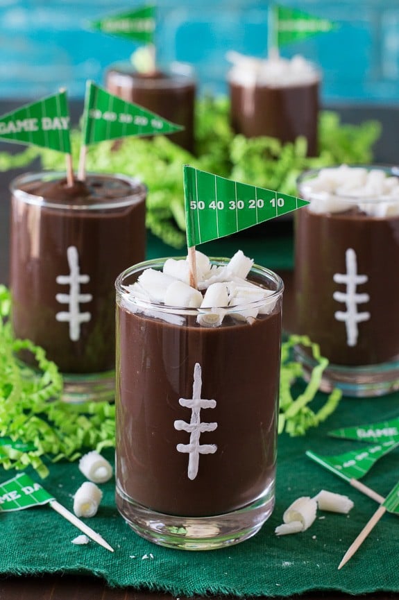 These football pudding cups are so cute for game day! Jazz them up with some white football stitches, chocolate curls, and a mini pennant! 