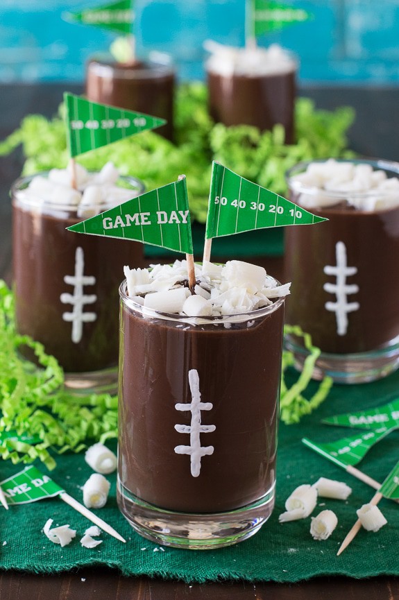 These football pudding cups are so cute for game day! Jazz them up with some white football stitches, chocolate curls, and a mini pennant! 