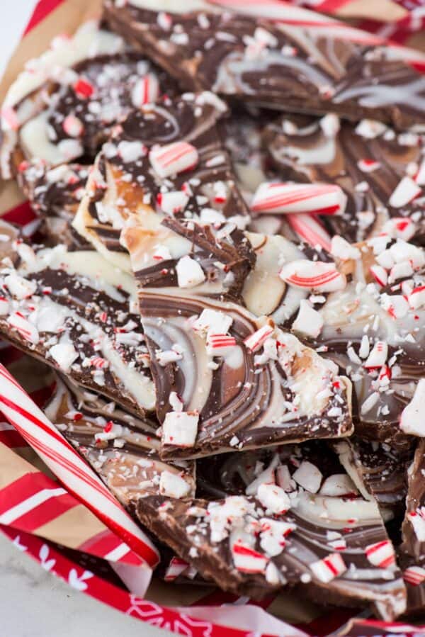 pieces of swirled chocolate and white chocolate peppermint bark on red tray