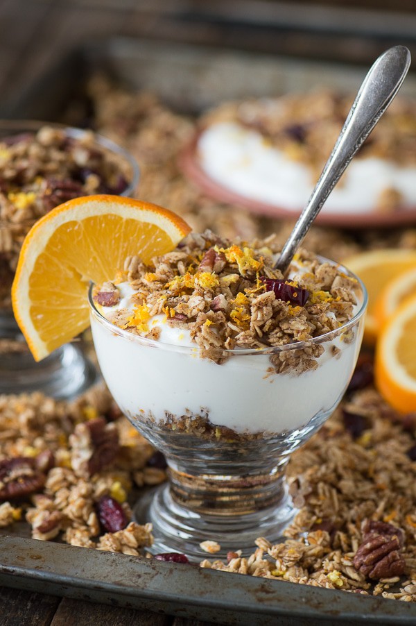 Homemade orange cranberry granola with orange zest, pecans, and dried cranberries! A soft granola that bakes in 8 minutes! 