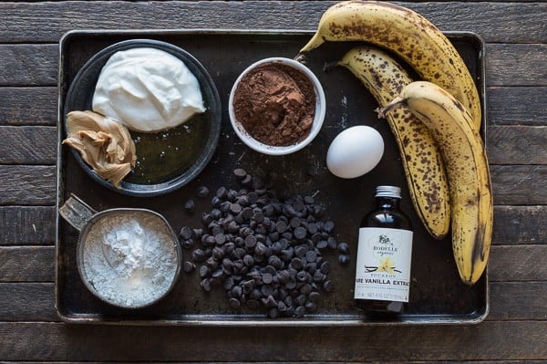 tray with baking ingredients - bananas, yogurt, peanut butter, flour, chocolate chips, egg