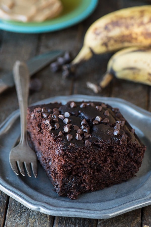 healthier chocolate cake on plate with bananas in background