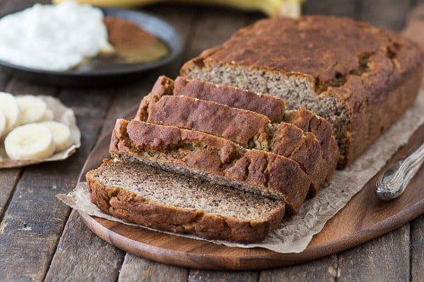 Healthier banana bread sliced on wood platter