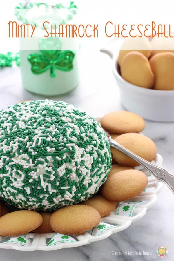 Minty Shamrock Cheese Ball with vanilla wafers on a st. patrick's day themed bowl.