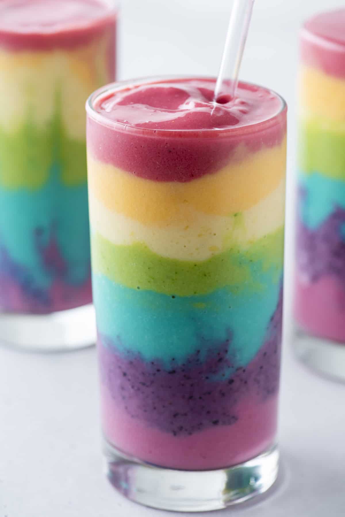 rainbow smoothie in a glass cup on a white background