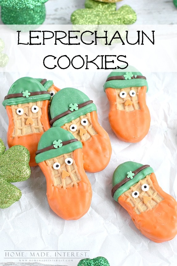 Six St Patrick’s Day Leprechaun Cookies on parchment paper.