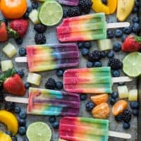 Outstanding 7 layer rainbow popsicles! Make your own homemade rainbow popsicles with lots of fresh fruit!